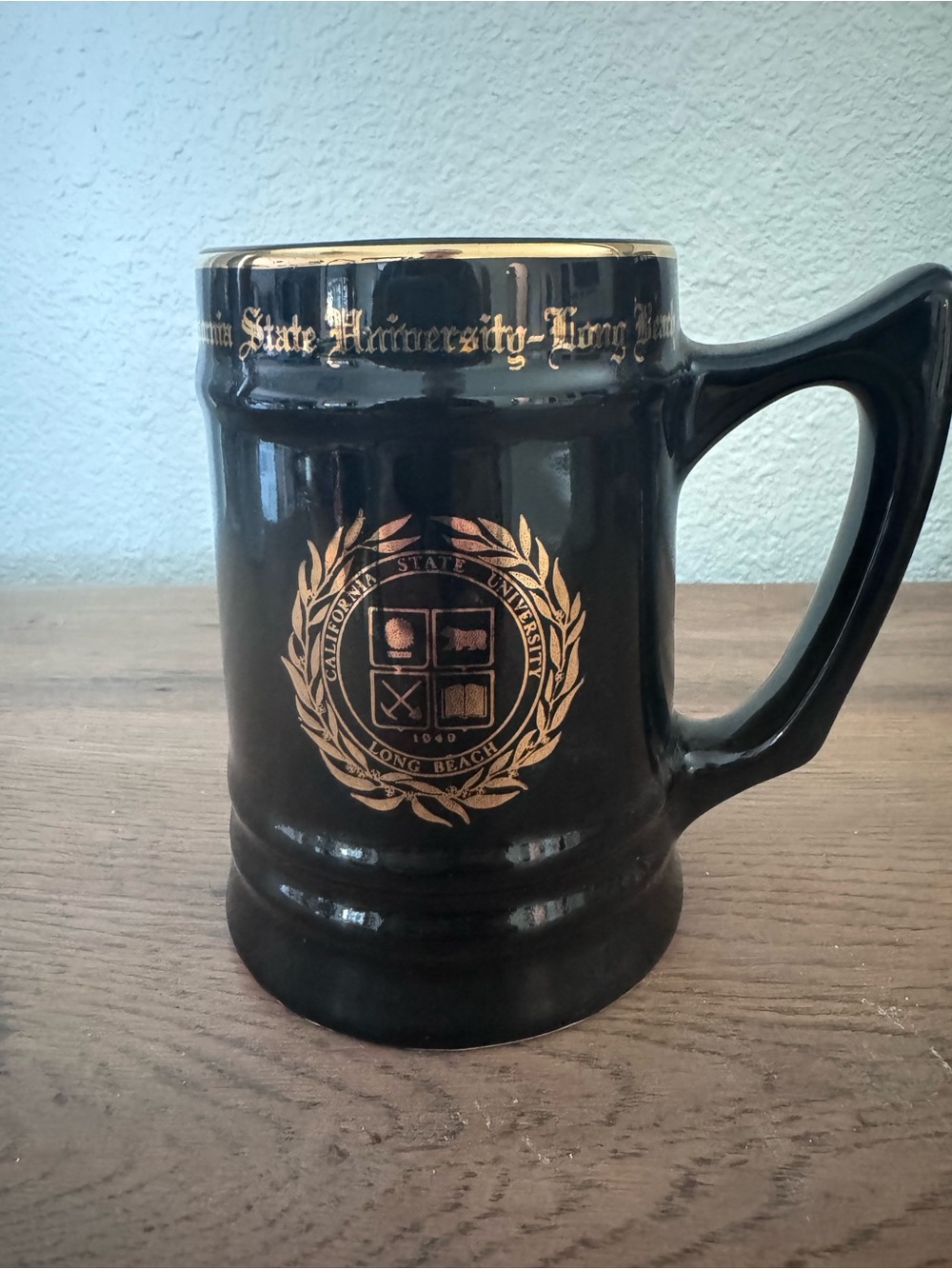 Black and Gold Ceramic Stein with University Crest